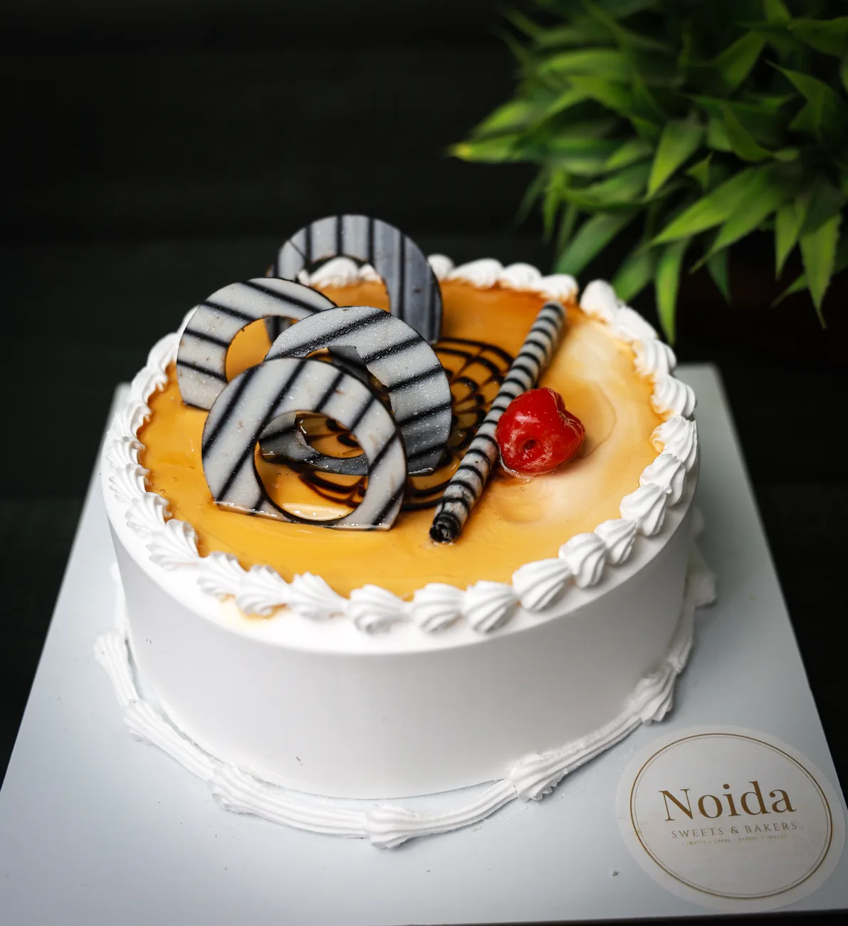 Butterscotch cake with caramel drip — made at Noida Sweets and Bakers