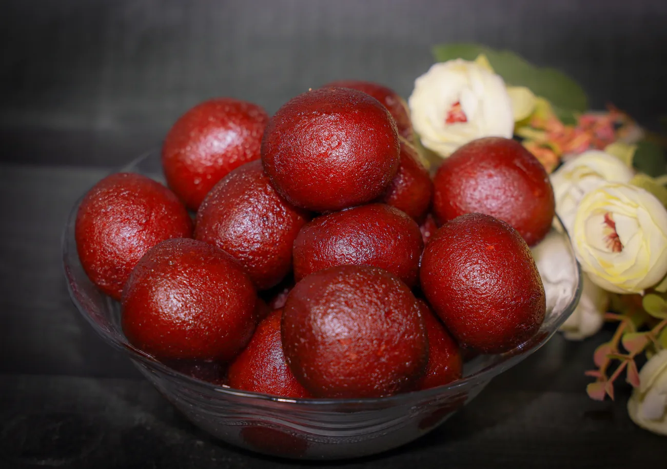 Gulab jamun in a glass bowl — our photo