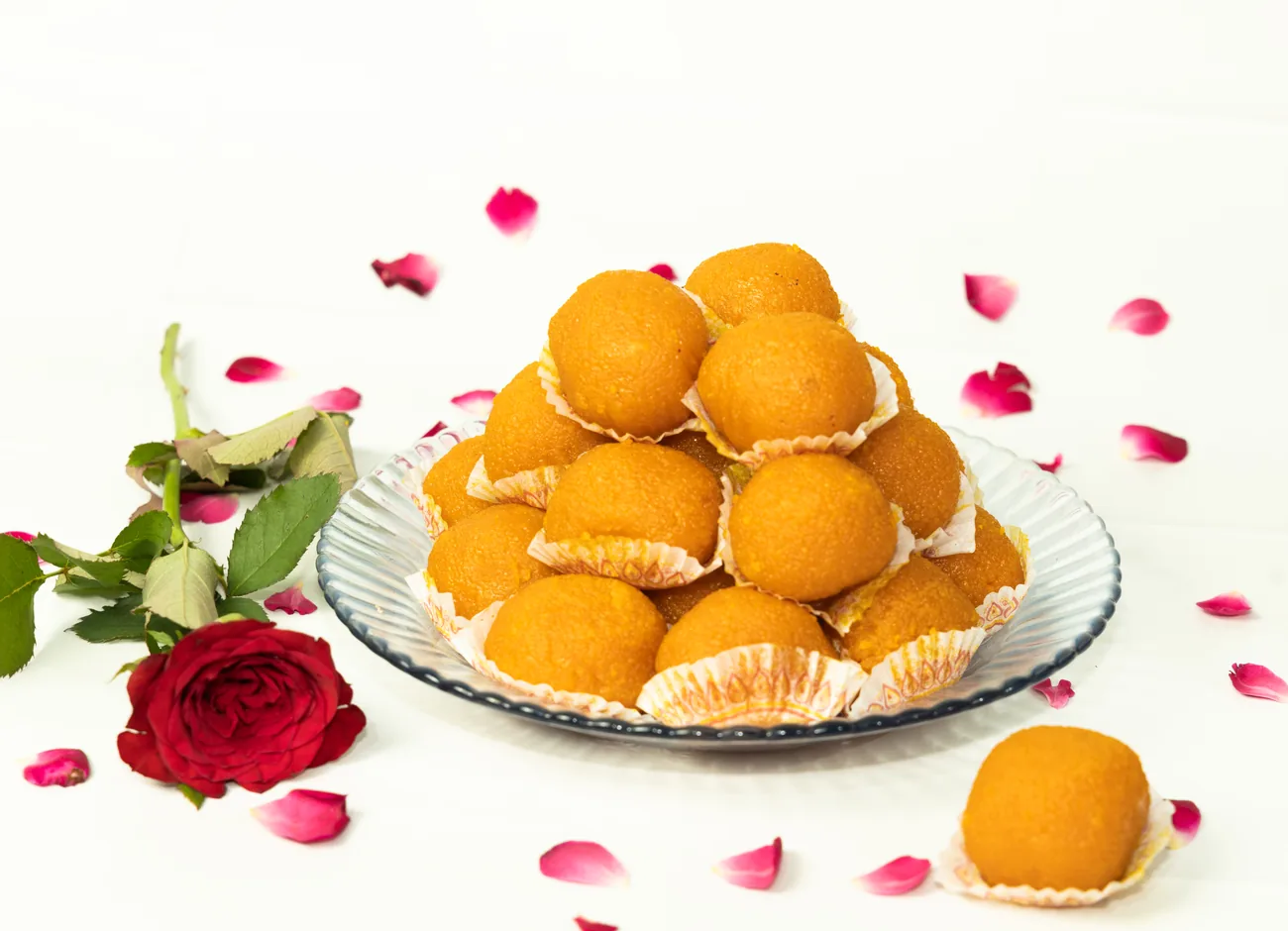 Motichoor laddu pyramid with rose petals — our photo