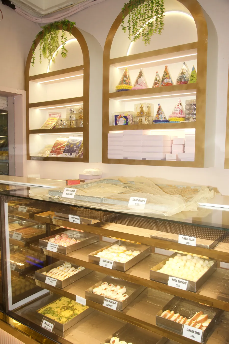 Arched displays and the fresh sweets counter inside Noida Sweets & Bakers, Supertech EcoVillage-1, Greater Noida
