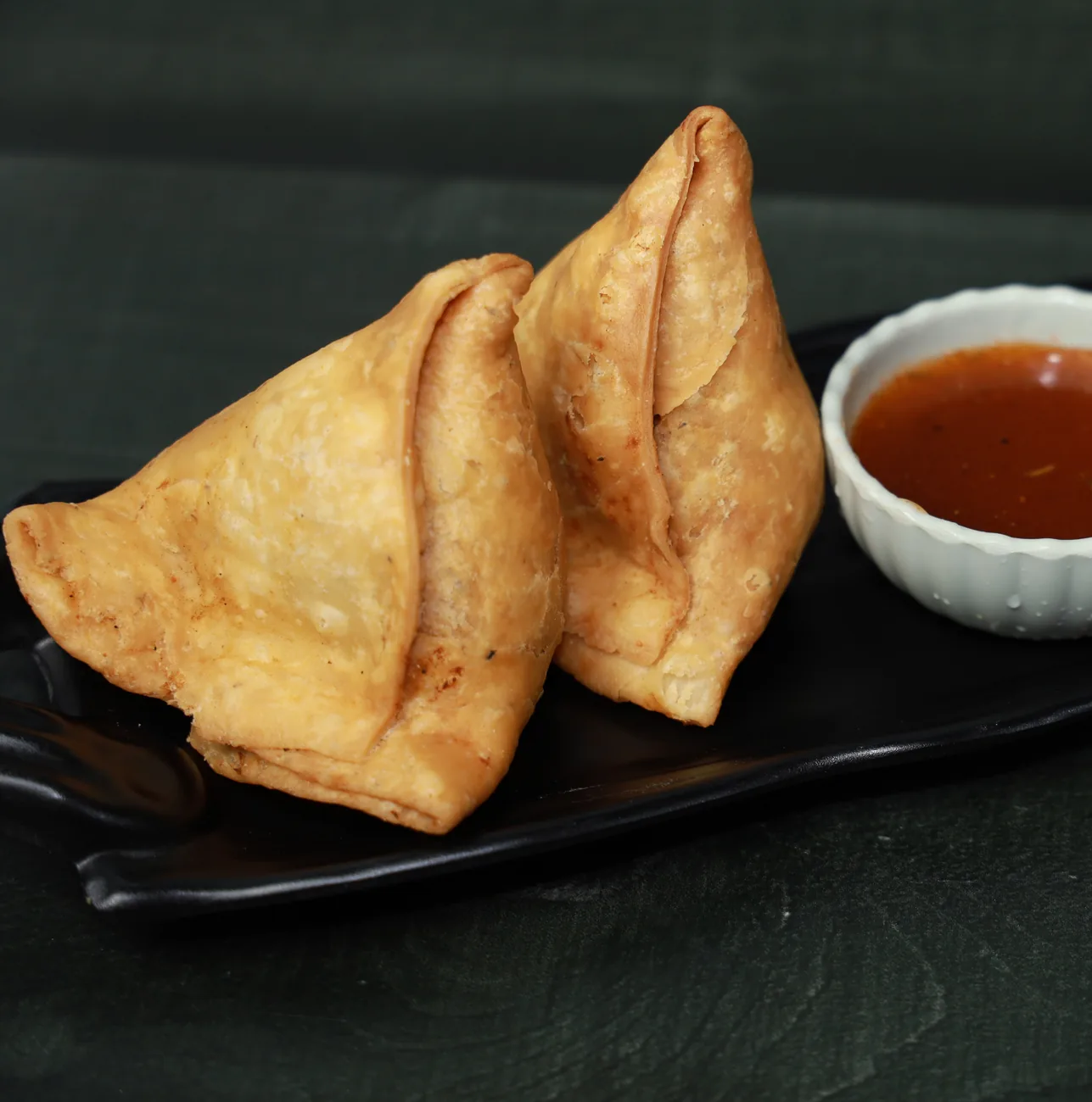 Fresh samosas with chutney at Noida Sweets and Bakers