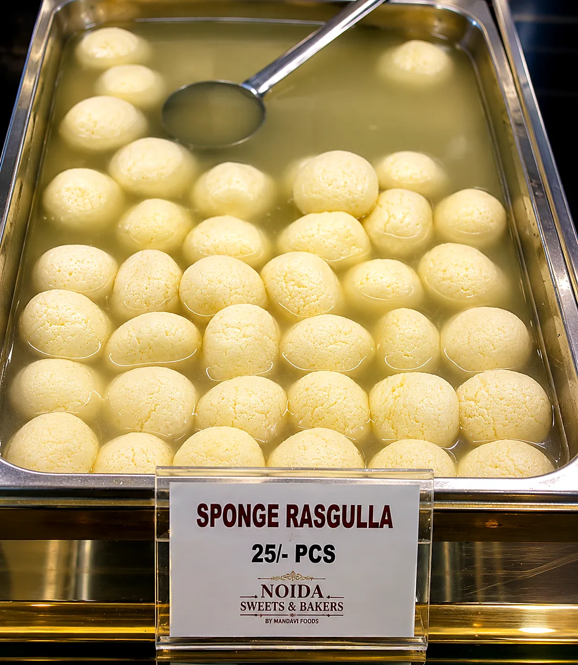 Sponge rasgulla tray in light syrup — our photo